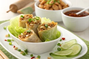 Egg roll in a bowl with coleslaw mix in a skillet garnished with green onions and sesame seeds