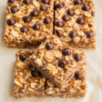 Close-up of banana oatmeal peanut butter bars topped with oats and chocolate chips.
