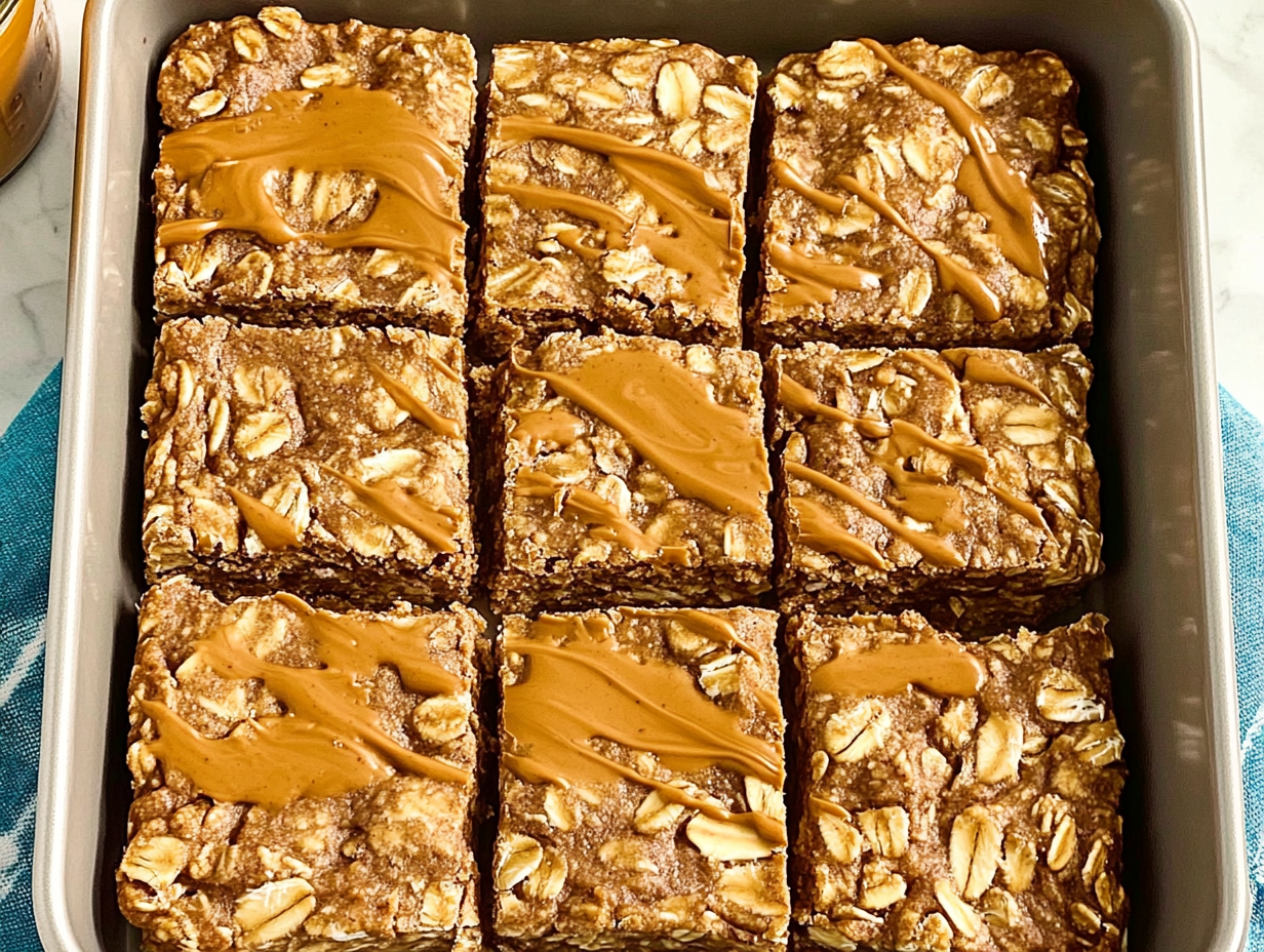 A pan of freshly baked High-Protein Peanut Butter–Banana Oatmeal Bars cooling on a wire rack.