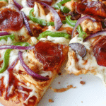 high protein pizza slice on white countertop