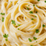 A bowl of pasta with creamy vegan alfredo sauce without cashews.