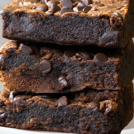 Protein brownies stacked on a white marble counte