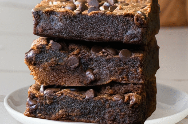 Protein brownies stacked on a white marble counte