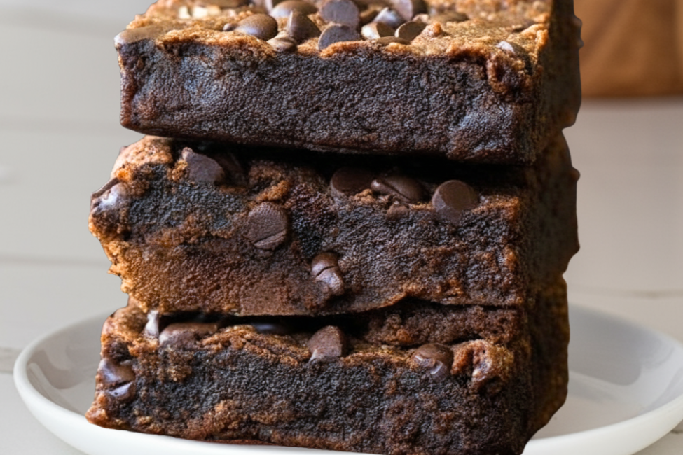 Protein brownies stacked on a white marble counte